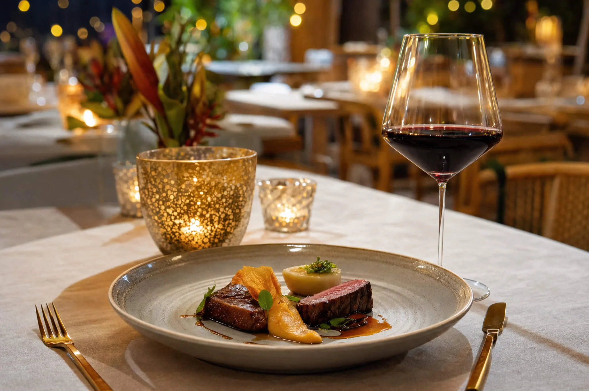 An elegant plated Colombian tasting dish on a restaurant table set for an awards-night dinner